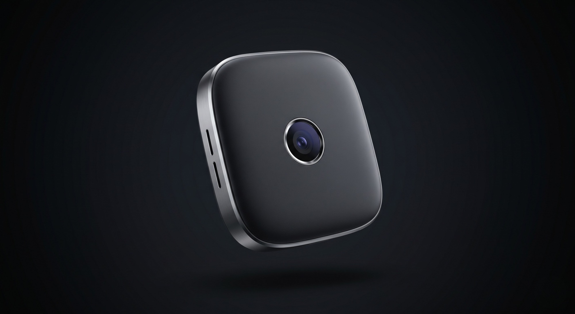 The Finn the Pin device: a small, rounded, dark magnetic pin with a central camera lens, floating against a dark background.
